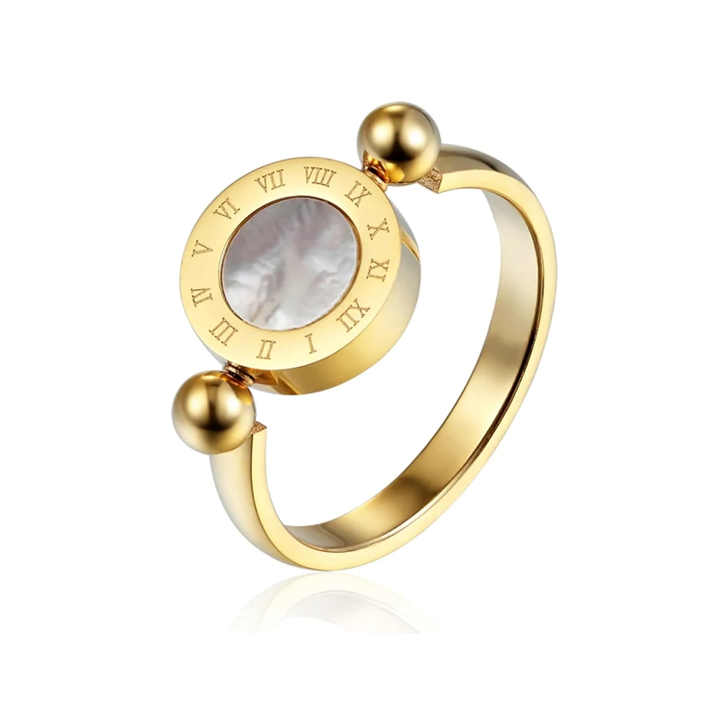 Gold-tone Roman numeral spinner ring with mother-of-pearl inset on a white reflective surface