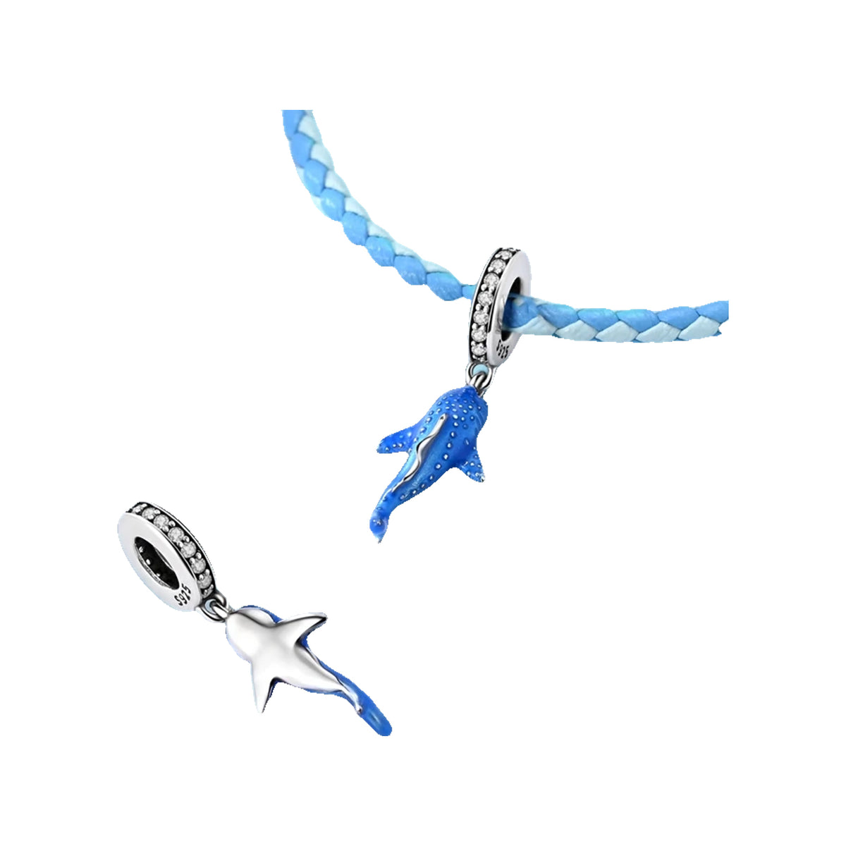 Two whale shark charms on a light-blue braided cord over a sandy seascape backdrop