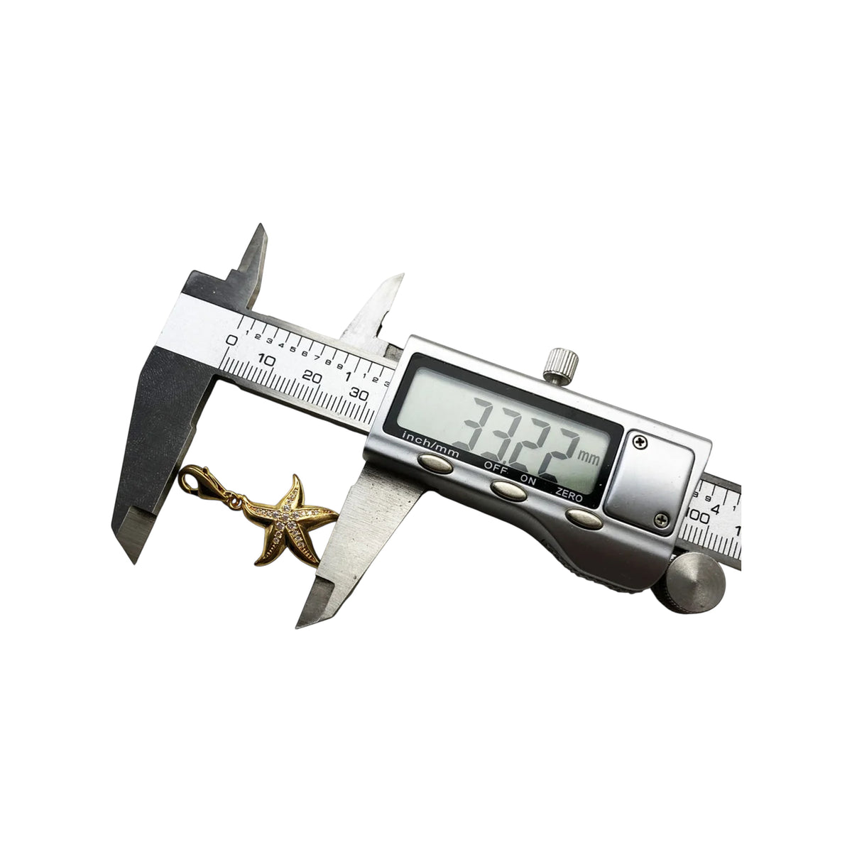 Gold-tone starfish charm shown with caliper measuring its size