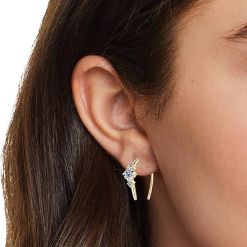 Three-stone U-hoop earring worn on the ear near the lobe