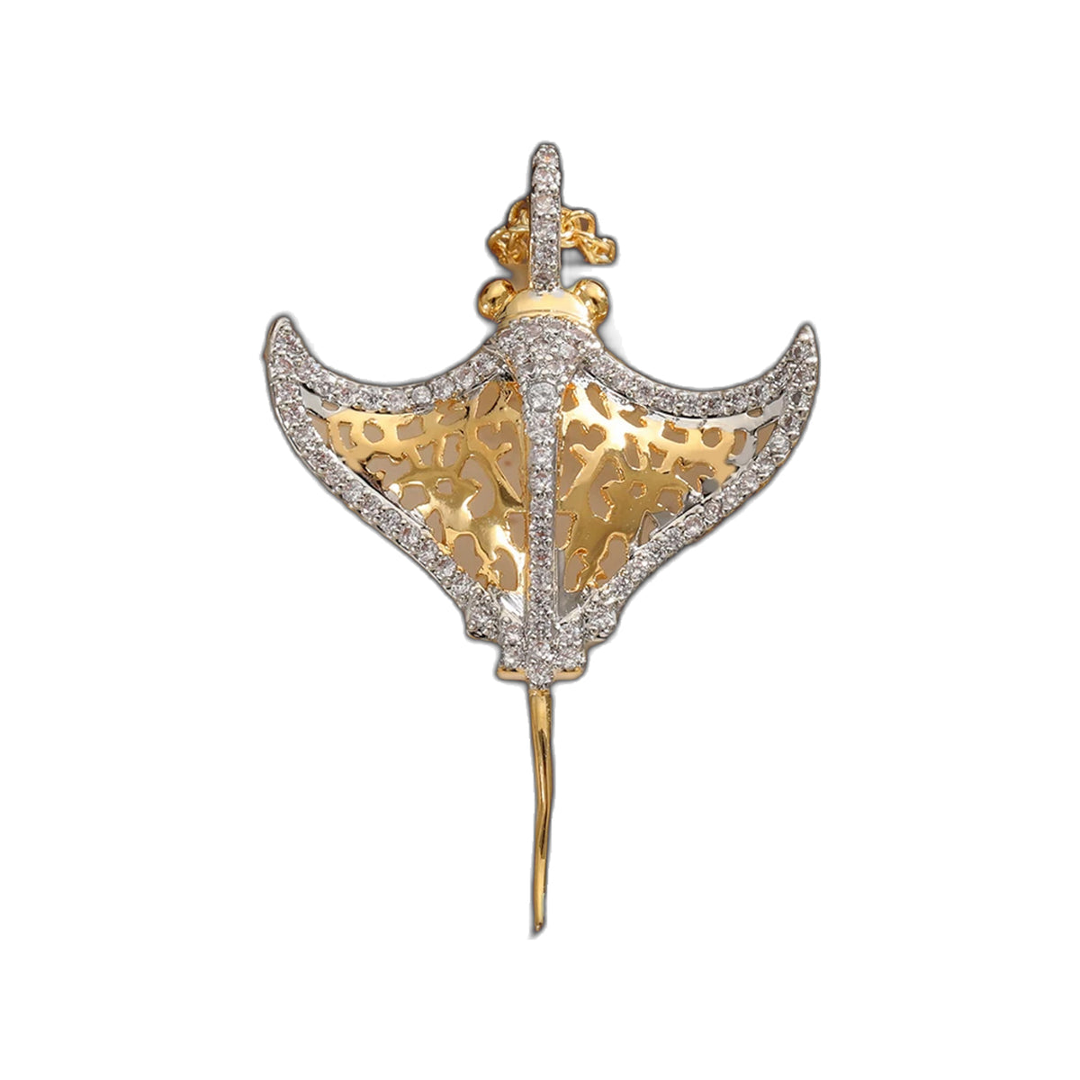 Manta ray pendant shown flat on cream surface beside gold-tone chain highlighting filigree center and crystal trim