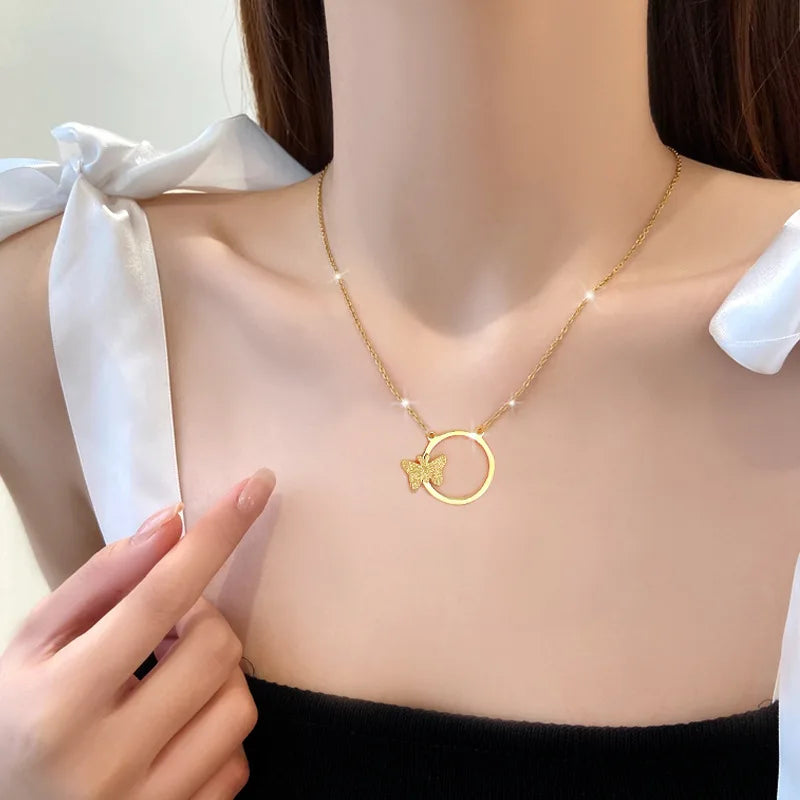 Gold-tone double-ring pendant necklace worn at the collarbone
