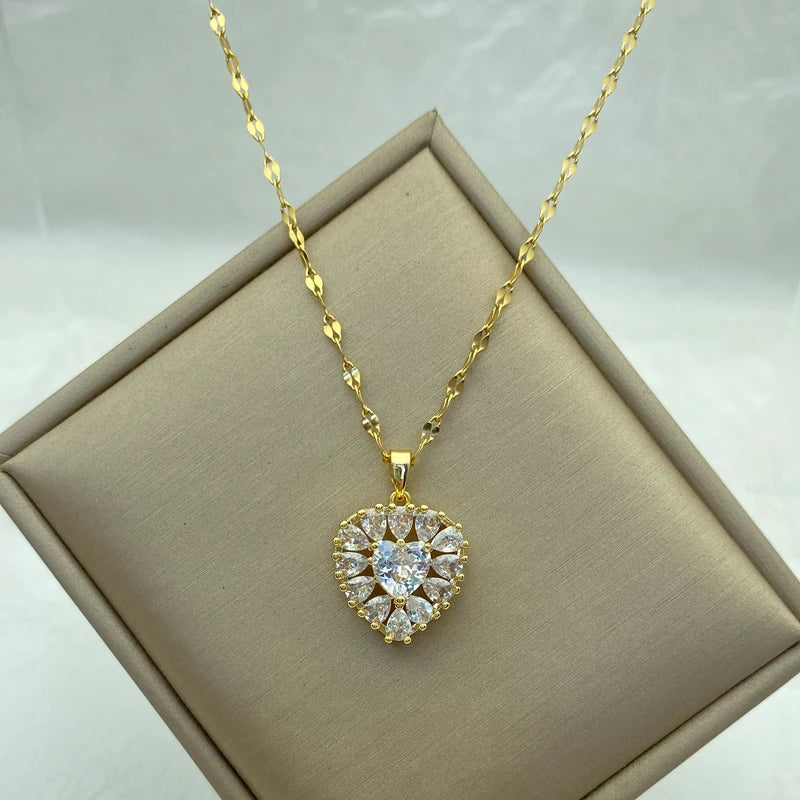 gold-tone heart cluster pendant necklace displayed on a beige jewelry box