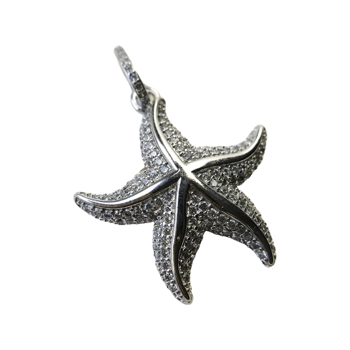 Close-up of a silver-tone pavé starfish pendant with polished raised lines and a bail for a chain.
