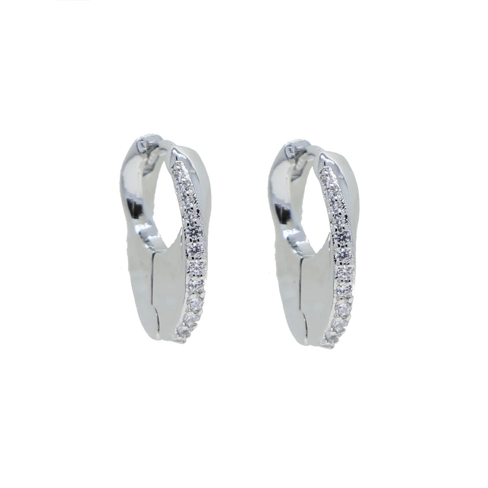 Silver-tone mini huggie hoops photographed alone highlighting the pavé curve