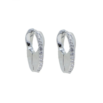 Silver-tone mini huggie hoops photographed alone highlighting the pavé curve