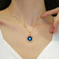 Round blue evil-eye gold-tone pendant necklace worn at the collarbone