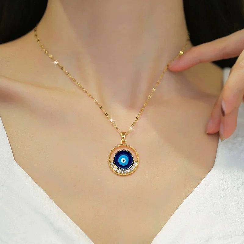 Round blue evil-eye gold-tone pendant necklace worn at the collarbone