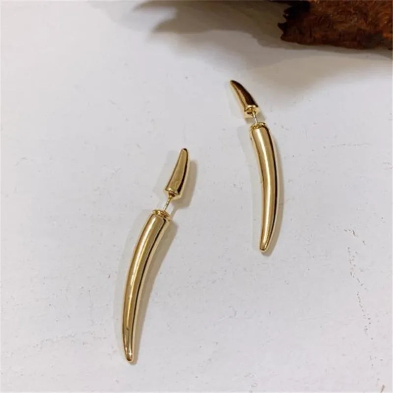 Gold-tone crescent claw long drops displayed flat on a white surface