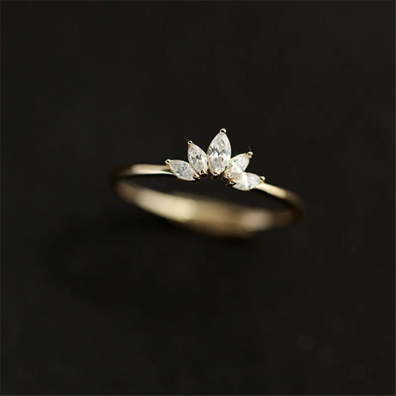 Gold-tone marquise crystal crown ring centered with a soft blurred background