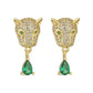 Front view of gold‑tone leopard head huggie earrings with pave stones and green teardrop dangles.