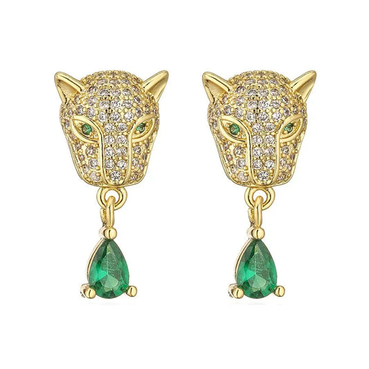 Front view of gold‑tone leopard head huggie earrings with pave stones and green teardrop dangles.