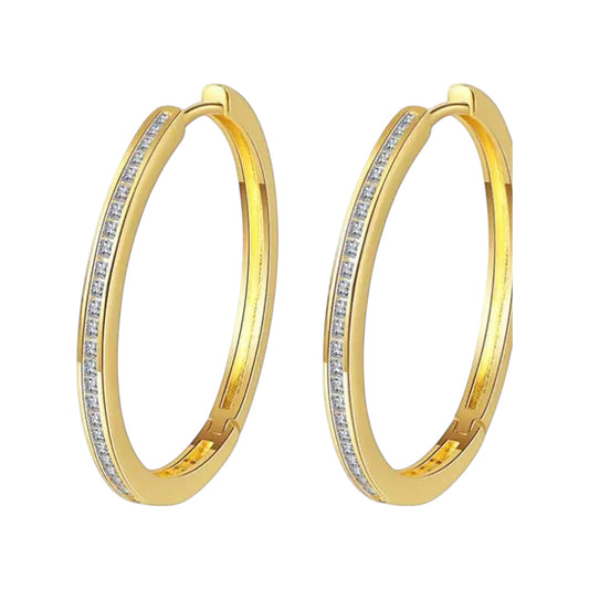 Pair of gold-tone hoop earrings with princess-cut clear stones along front edge