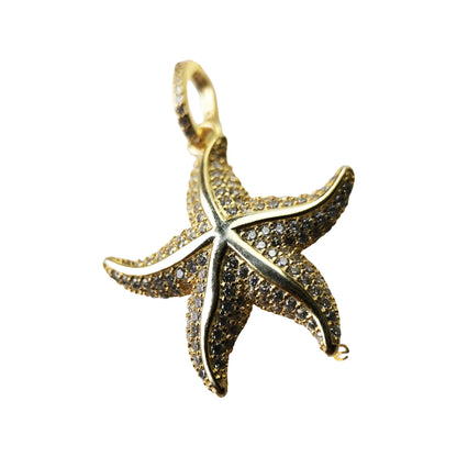 Close-up of gold-tone pavé starfish pendant highlighting raised arms and sparkling stones