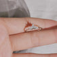 Silver-tone marquise crystal crown ring worn across the fingertips