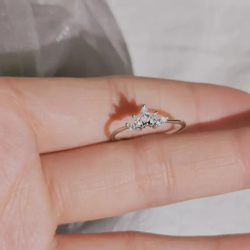 Silver-tone marquise crystal crown ring worn across the fingertips