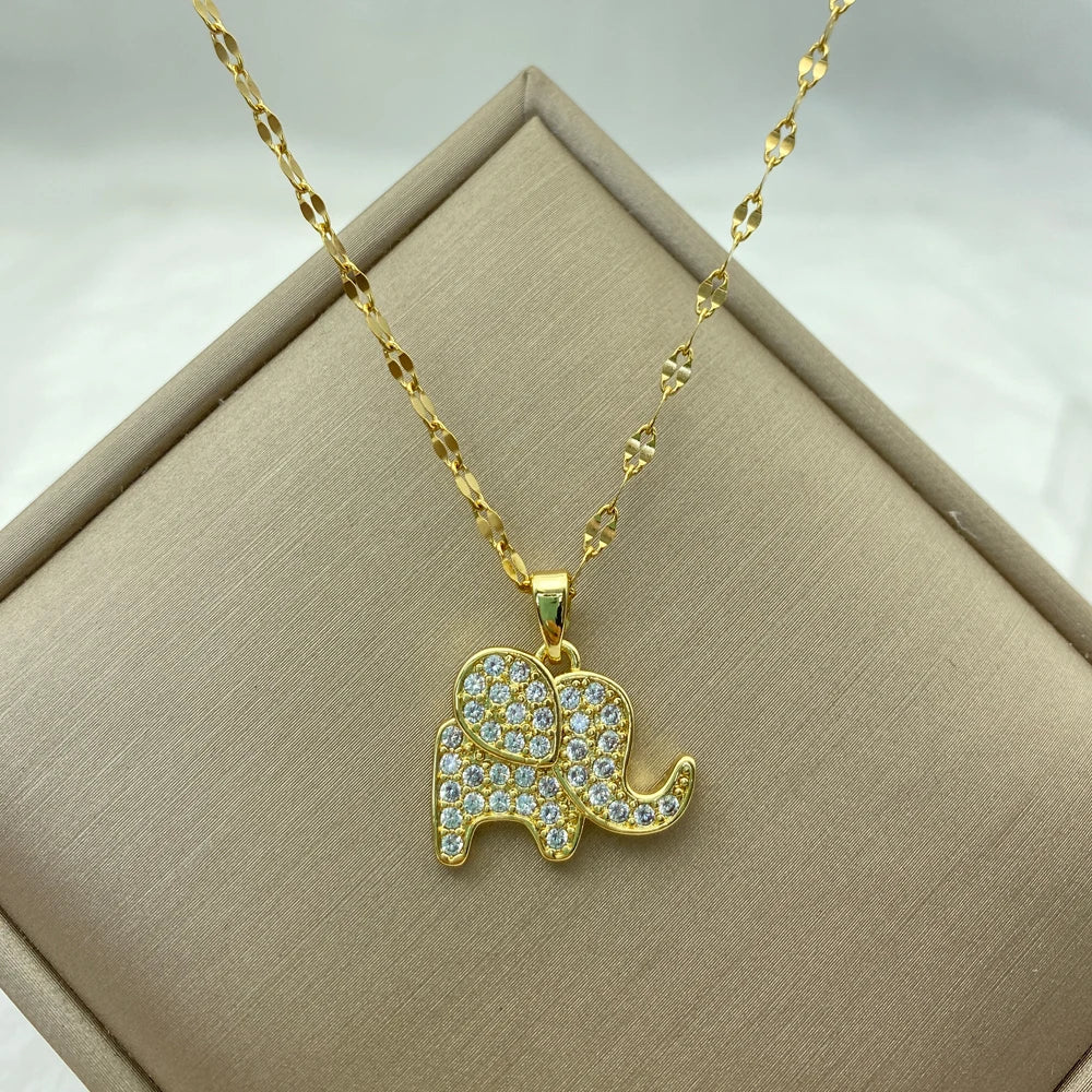 gold-tone elephant silhouette pendant outlined with clear pavé stones on a patterned chain