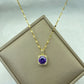 gold-tone pendant with purple cushion center stone and surrounding clear accents on a chain