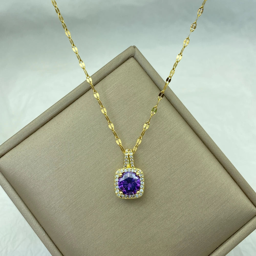 gold-tone pendant with purple cushion center stone and surrounding clear accents on a chain
