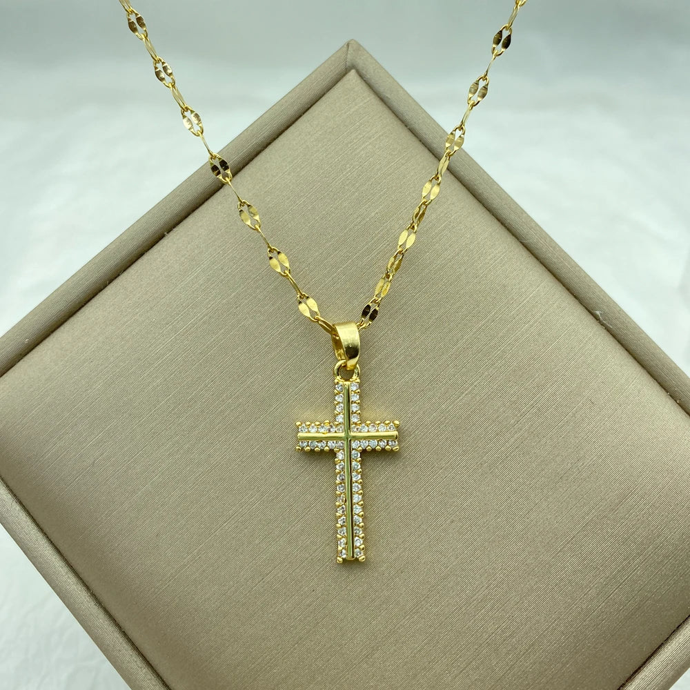 gold-tone cross pendant set with pavé clear stones on a delicate patterned chain