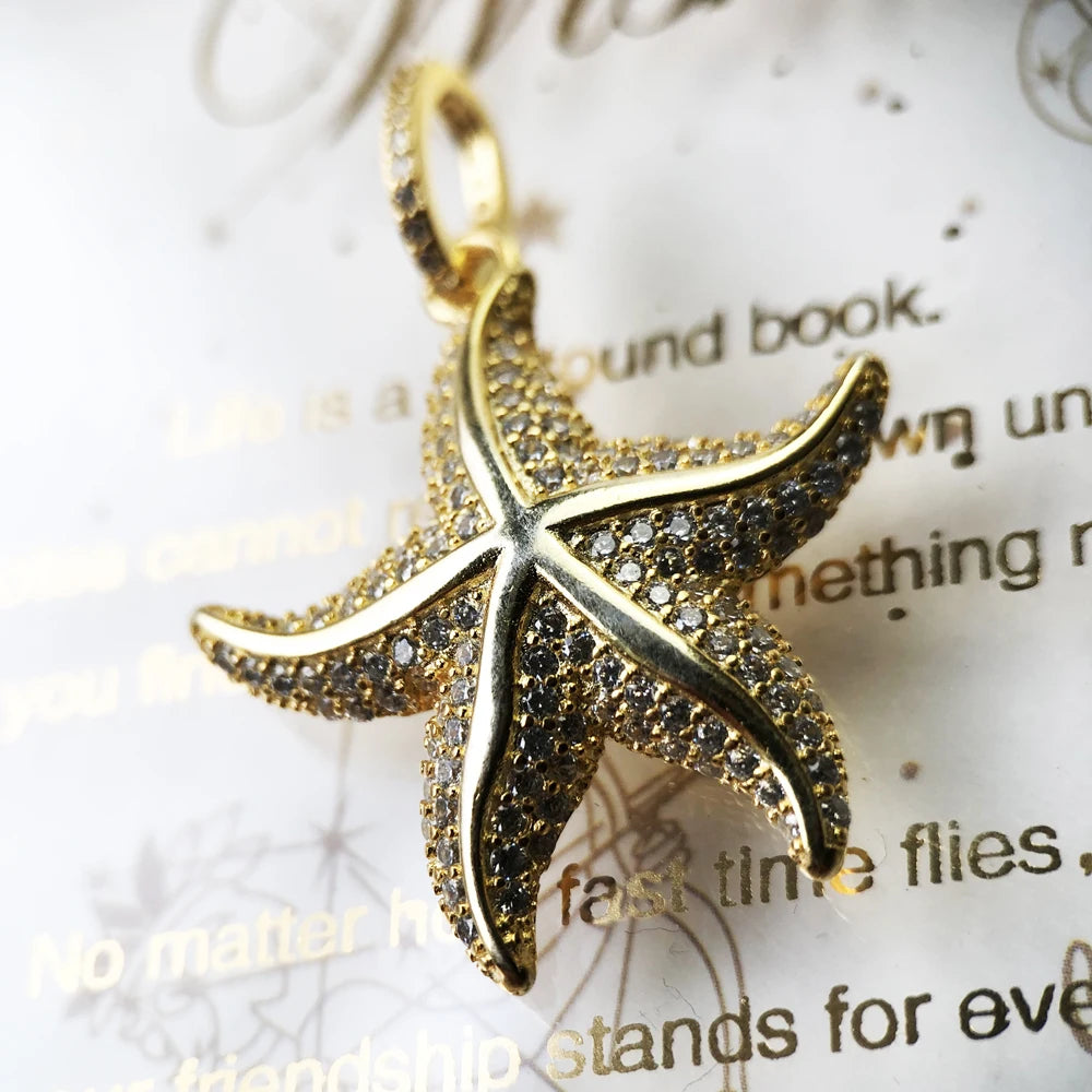 Close-up of gold-tone pavé starfish pendant highlighting raised arms and sparkling stones
