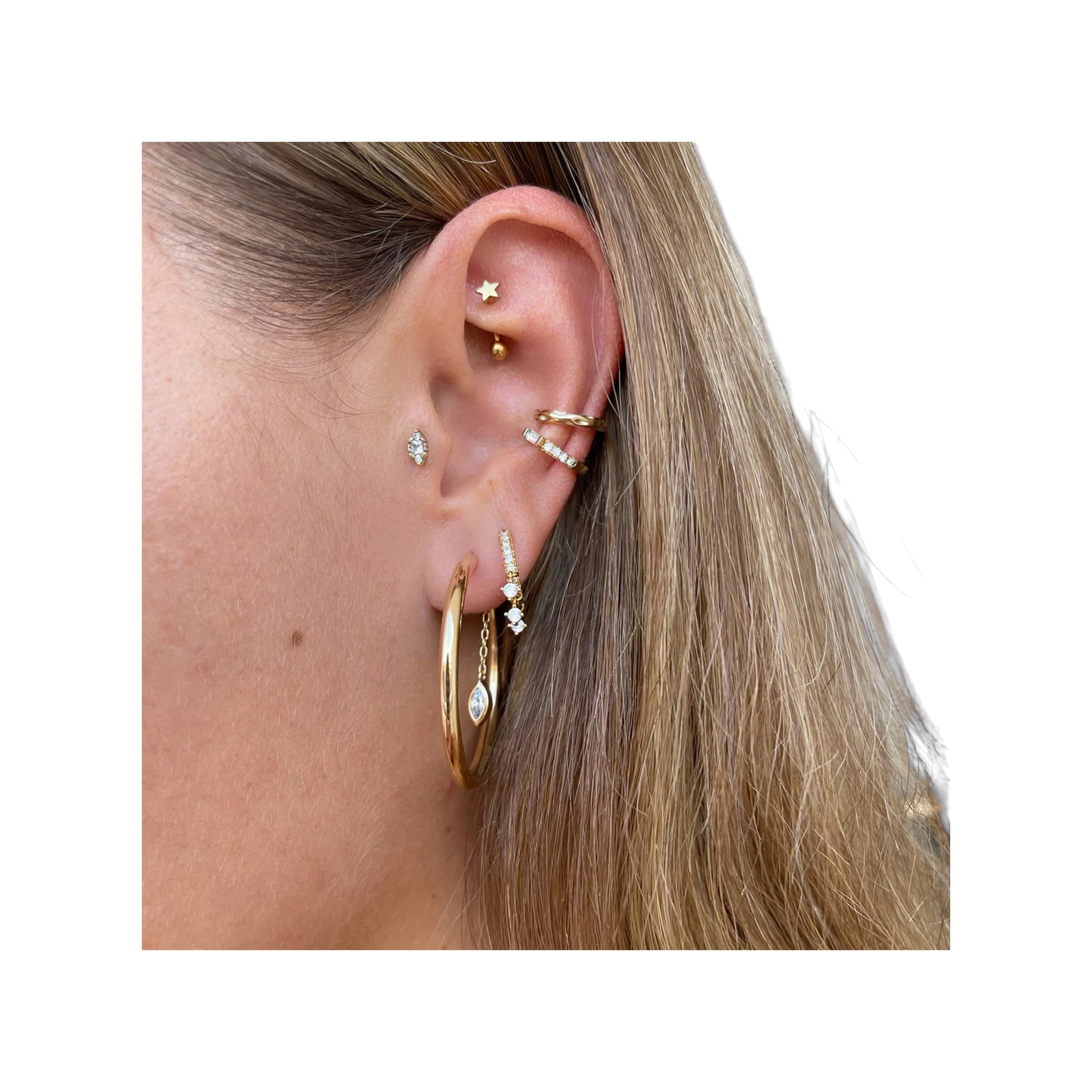 Gold-tone 25 mm hoop with marquise chain dangle worn at the earlobe among multiple piercings