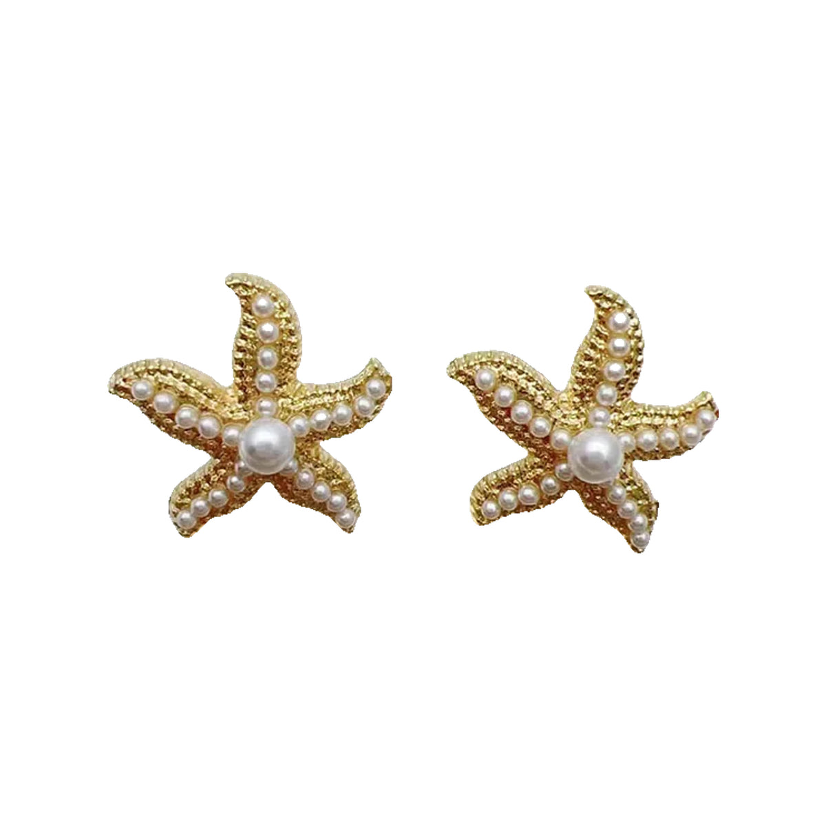 Gold-tone starfish stud earrings with pearl beads on a round textured white plate