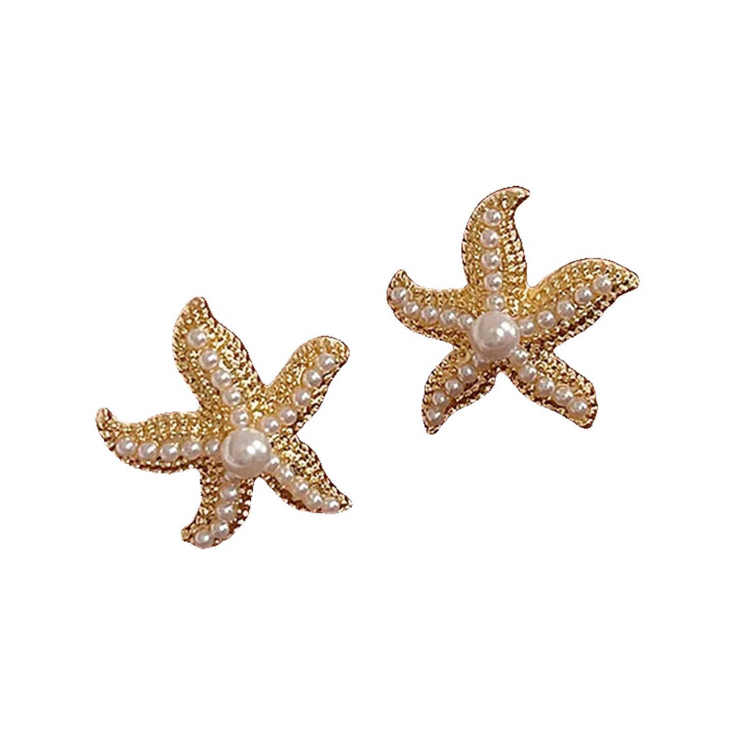 Gold-tone starfish studs with pearl beads resting on a tan leather surface