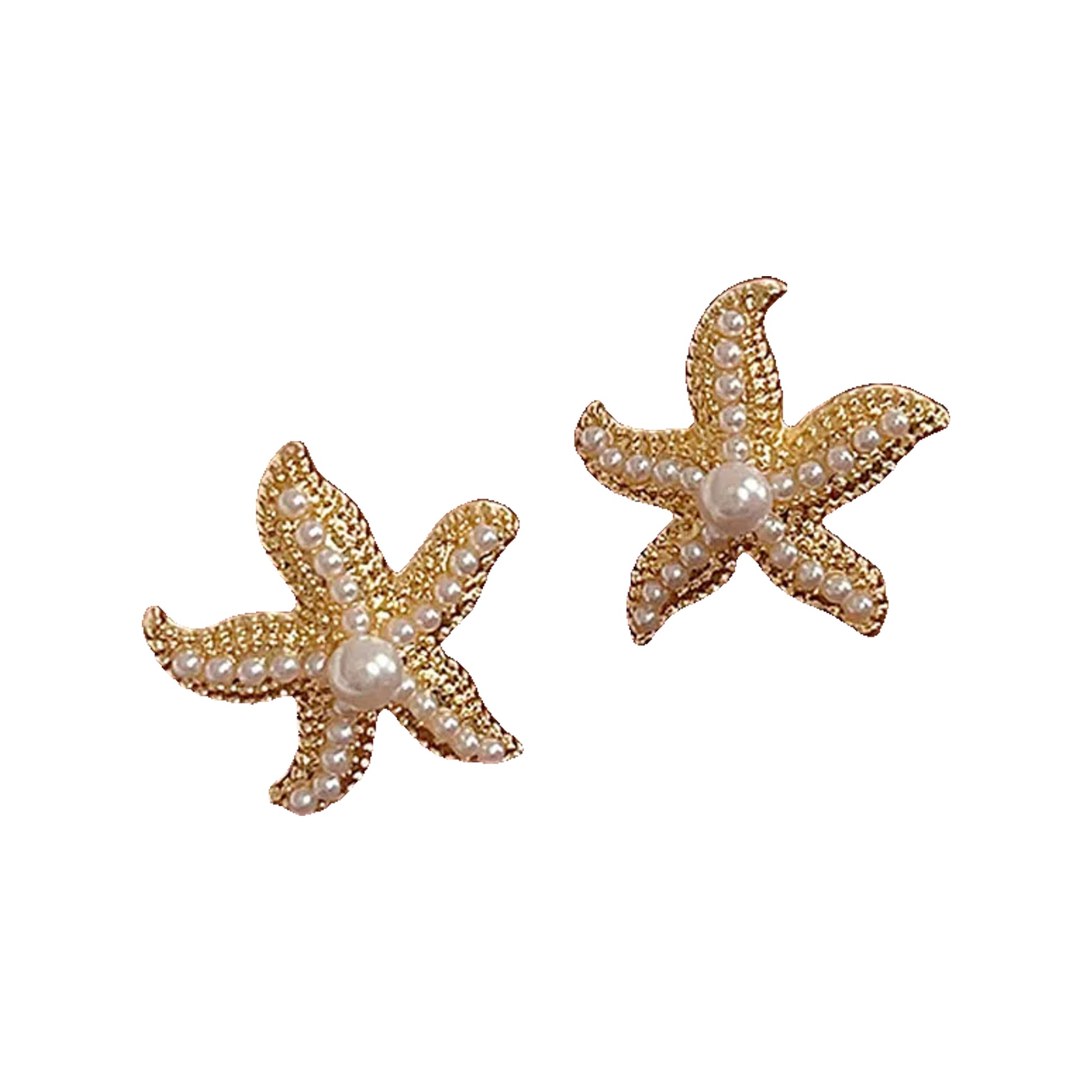 Gold-tone starfish studs with pearl beads resting on a tan leather surface