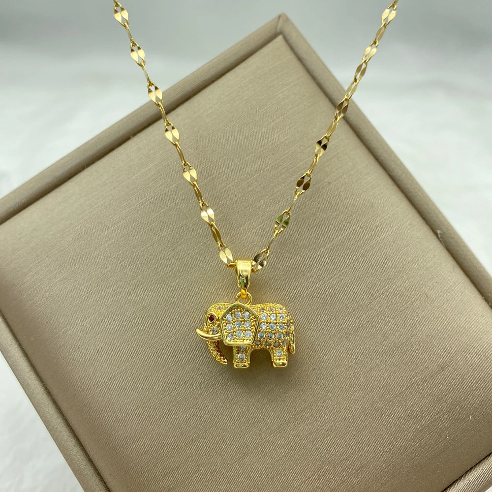gold-tone elephant pendant encrusted with clear stones hanging from a patterned chain