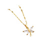 Gold-tone butterfly pendant necklace with four clear marquise stones on a textured link chain, displayed on a beige box.