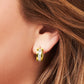 Close-up of a gold-tone huggie hoop with channel white stones worn at the earlobe