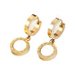 Gold-tone Roman numeral hoop drops with white disc centers resting on a printed page