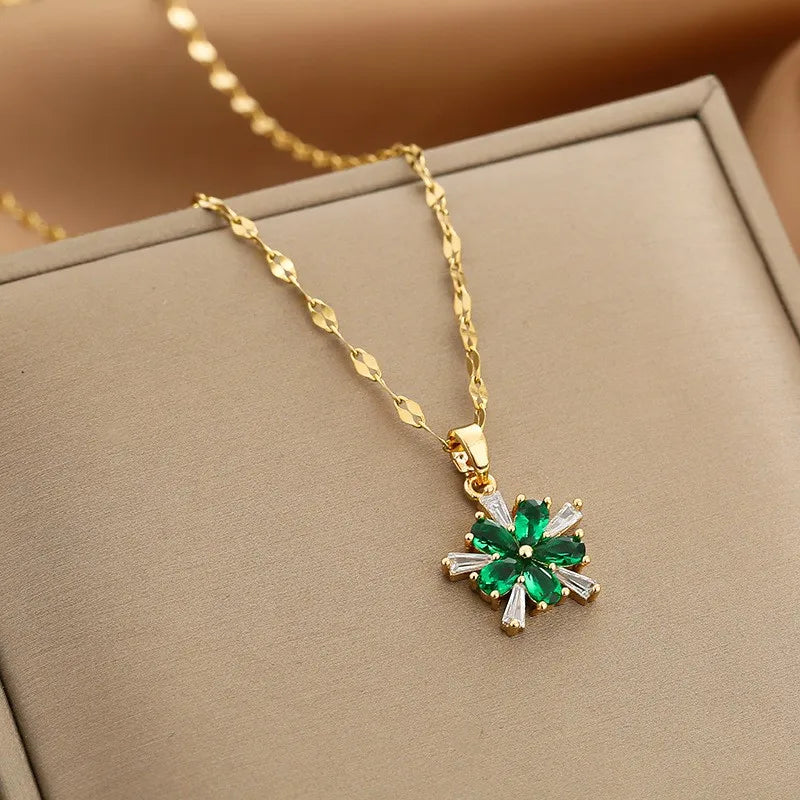 gold-tone pendant necklace with green floral cluster and baguette clear accents