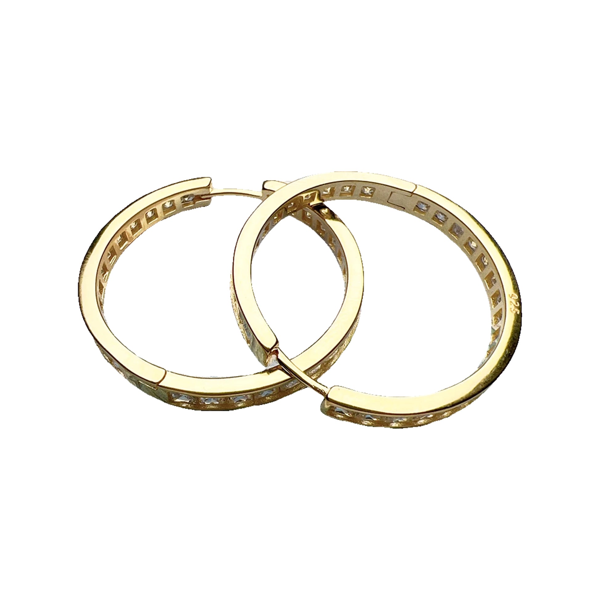 Two gold-tone hinged hoops with clear channel-set stones shown flat on a painted seascape