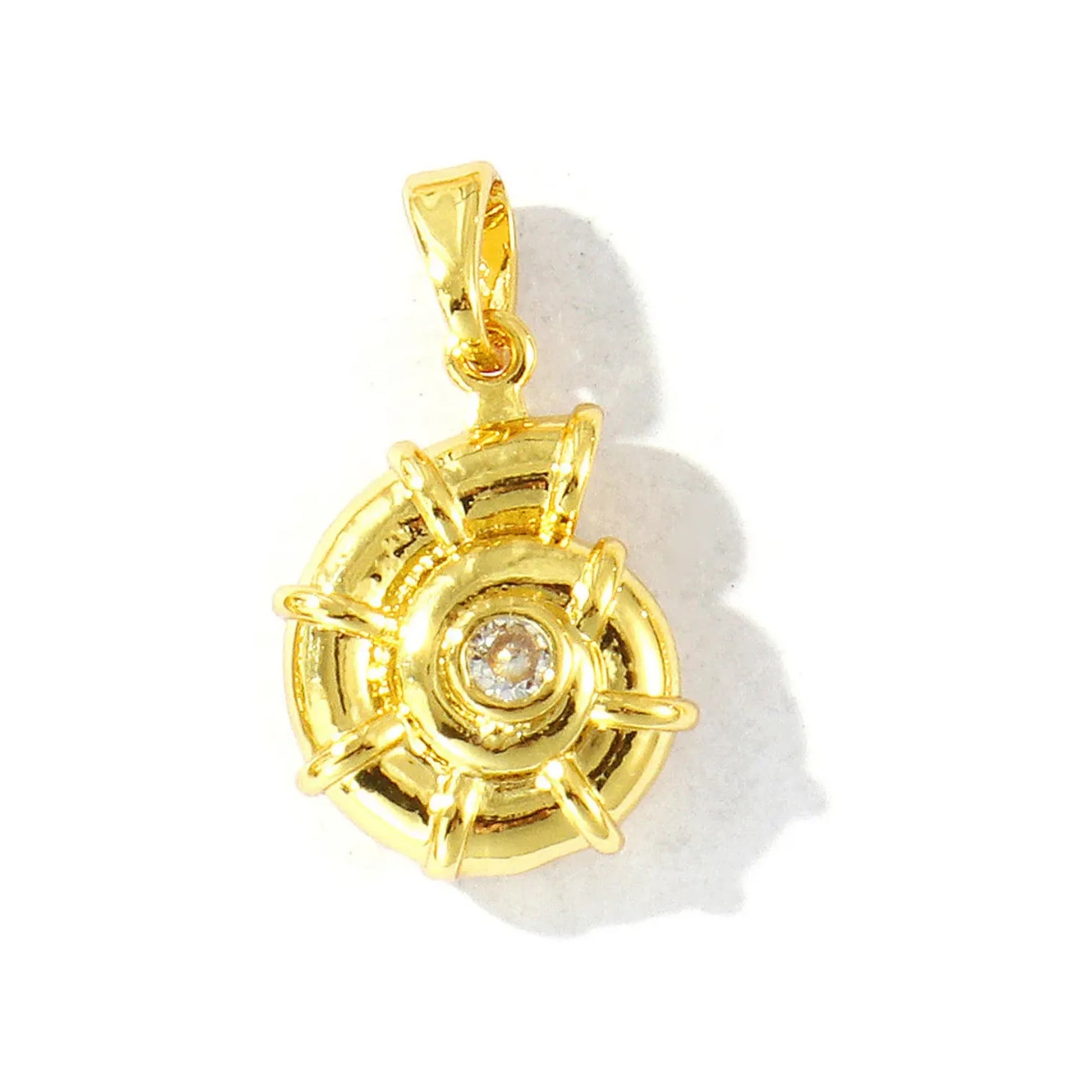 Compact gold-tone openwork charm with spoke design and central crystal