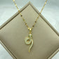 gold-tone snake pendant with pavé clear stones and green stone eyes on a fine chain