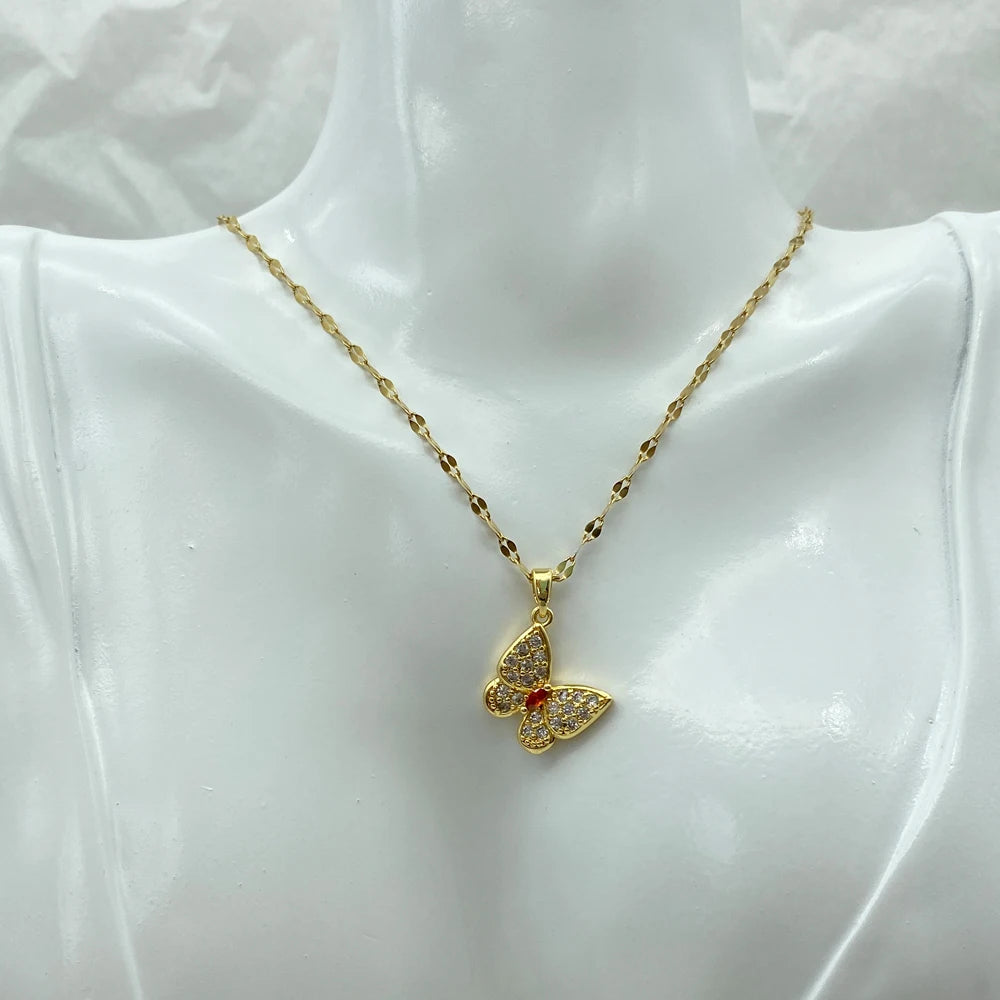 gold-tone butterfly pendant necklace worn at the collarbone on a display bust