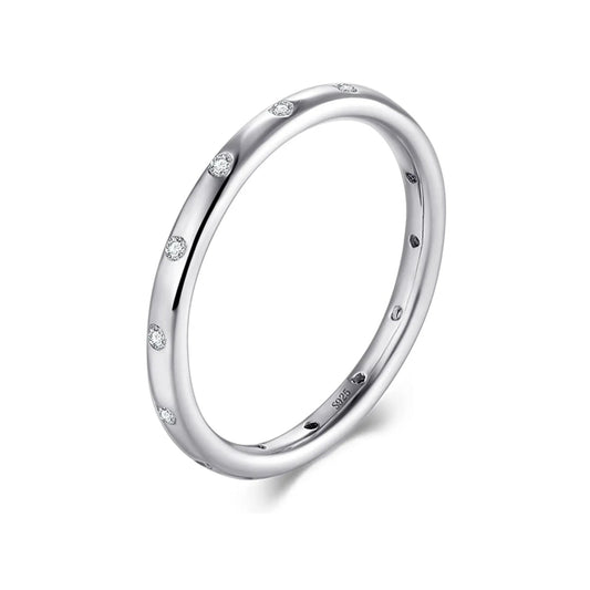 Slim scattered-stone band ring in silver-tone on white background