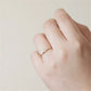 Gold-tone marquise crystal crown ring worn on the ring finger
