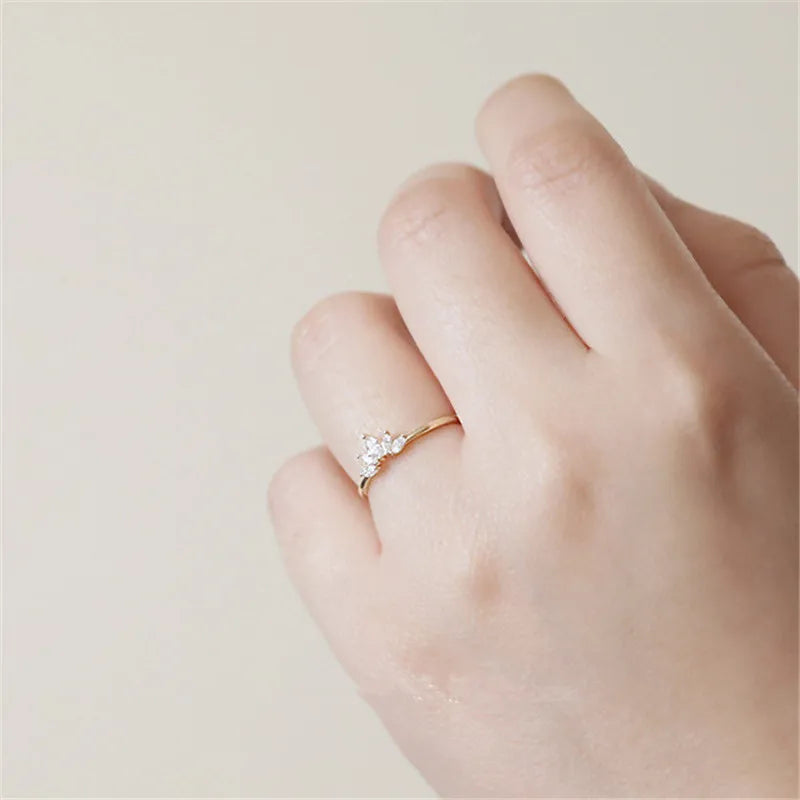 Gold-tone marquise crystal crown ring worn on the ring finger