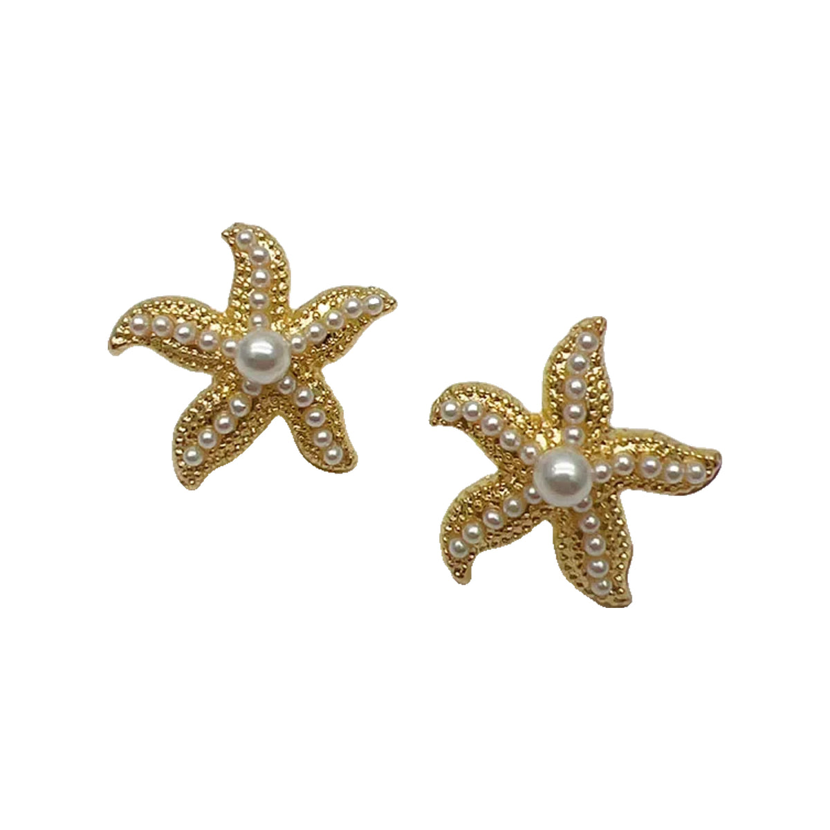 Gold-tone starfish stud earrings with pearl centers on a scalloped white dish