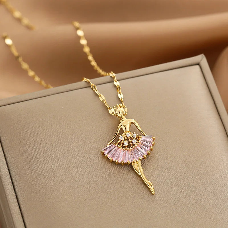 gold-tone ballerina pendant necklace with pink fan skirt displayed on a jewelry box