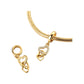 Gold-tone linked heart dangle charm with small crystal accents displayed on a snake bracelet