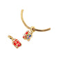 Gold-tone red suitcase charm with multicolor gem accents on a snake-chain bracelet