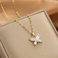 butterfly pendant necklace with four clear marquise wings shown draped on a beige display
