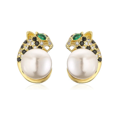 Gold-tone leopard head stud earrings cradling large round pearl accents on white background