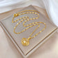 Gold-tone shell pendant necklace arranged on satin and a neutral box for a styled flat lay