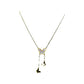 881ba219-0e86-4b5c-a1f6-5d59e8ab32b3 gold-tone butterfly lariat necklace worn at the center chest over a turtleneck