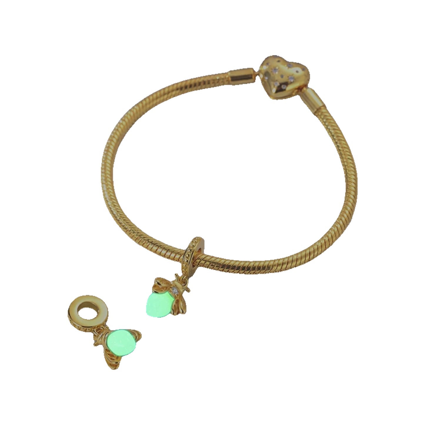 Gold-tone bracelet with bee charms and glow-in-the-dark stone accents displayed on a tabletop